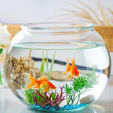 Glass fishbowl with goldfish, plants, and pebbles on a light background