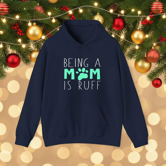 Navy blue hoodie with 'Being a Mom is Ruff' text on a background with orange leaves.