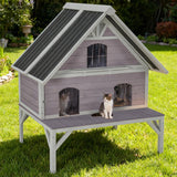 Wooden cat house with cats inside on a grassy outdoor setting