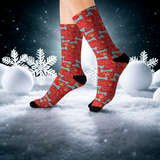 Red patterned socks worn in a snowy landscape with snowflakes.