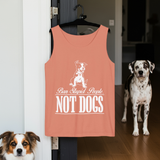 Peach tank top with a dog graphic and text, hanging on a door with two dogs in the background.