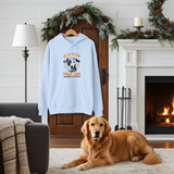 Light blue hoodie with dog graphic and text in a cozy living room with a fireplace.