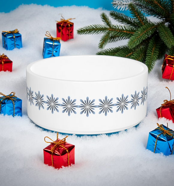 White decorative bowl with snowflake pattern surrounded by small gift boxes on a snowy background
